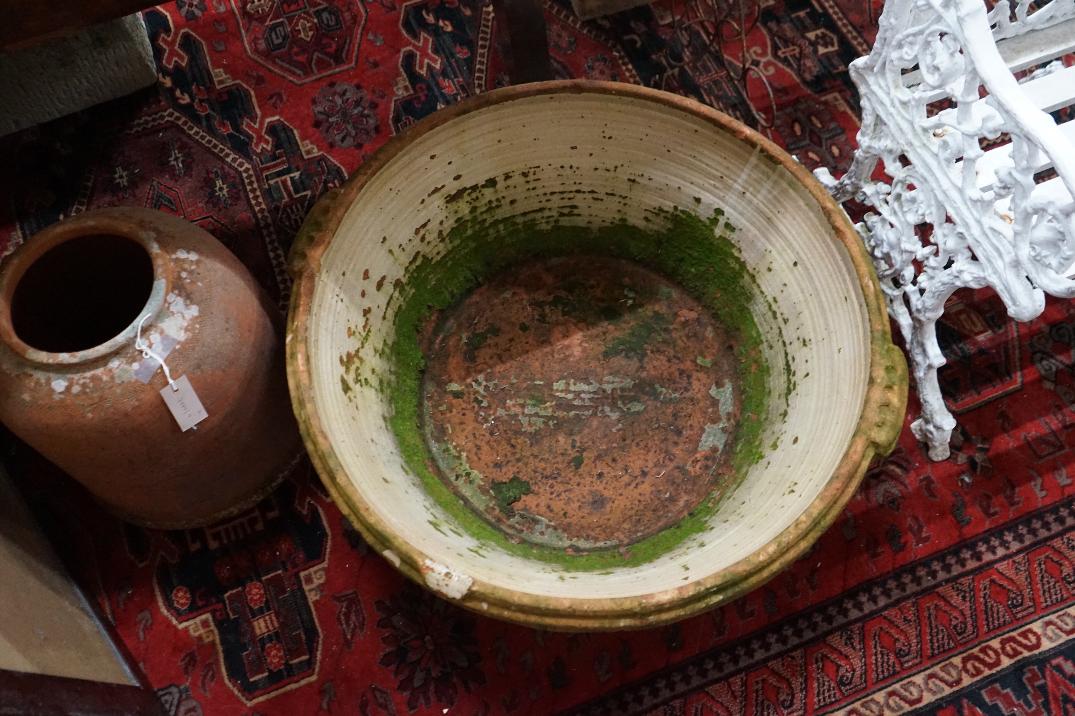 A large circular terracotta pail and a rhubarb planter, larger width 84cm, height 30cm